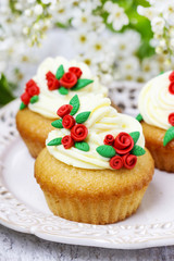 Beautiful rose cupcake and bird cherries in the background