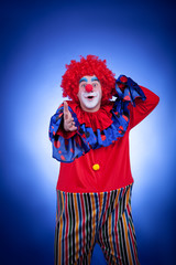 Smiling clown on blue background