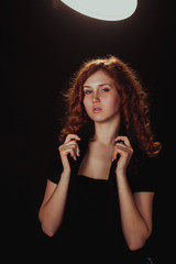 portrait of a glamorous young woman on dark background