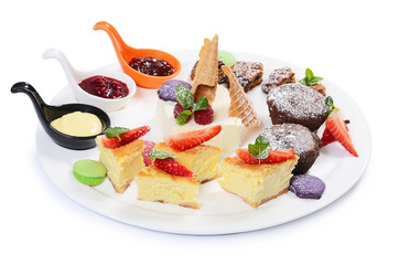 Plate of different desserts isolated