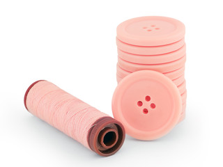 pink sewing buttons and thread isolated