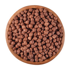 Chocolate cereal balls in a wooden bowl on a white