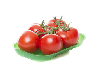Fresh tomatoes isolated on white background in green tray