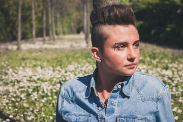 Short hair girl sitting in the grass