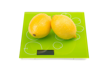 Two yellow lemon on scales