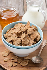cereal flakes in a bowl, milk and honey