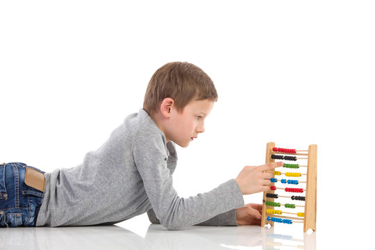 Schoolboy using an abacus