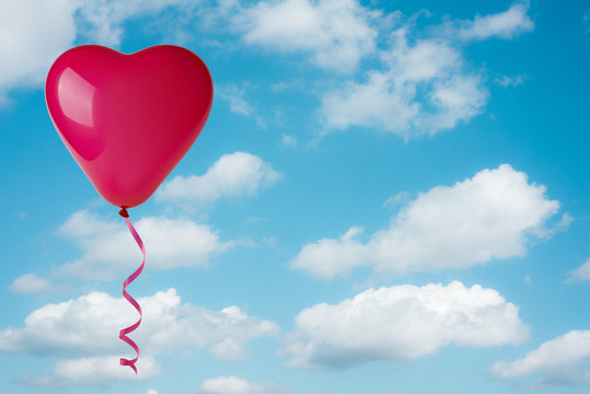 Heart shape balloon on sky background