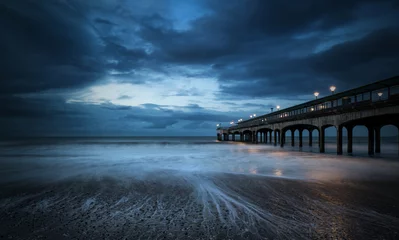 Deurstickers Twilight dusk landscape of pier stretching out into sea with moo © veneratio