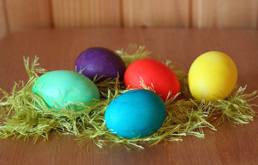 Five bright easter eggs on a wooden background