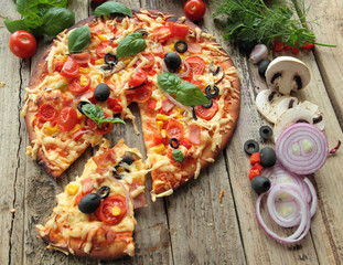 Pizza with ham fresh tomatoes olives and onion