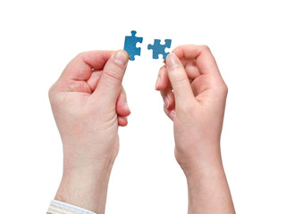 male and female hands with little puzzle pieces