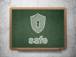 Privacy concept: Shield With Keyhole and Safe on chalkboard