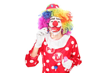 Funny clown blowing bubbles