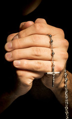 Praying Hands with rosay in black background