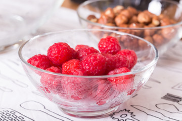 raspberries hazelnuts and butter in glass bowls