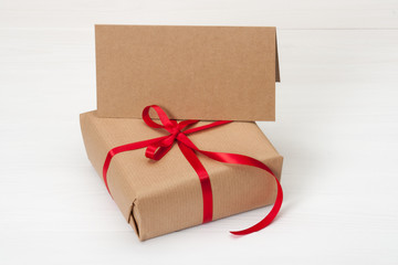 Gift Box And Card On White Wooden Background