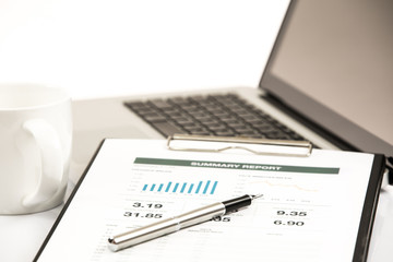 Businessman analyzing investment charts on laptop