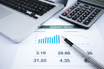 Businessman analyzing investment charts with laptop