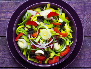 Fresh colorful vegetable salad platter wooden table