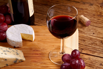 A red glass of wine and cheese