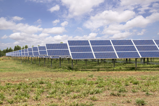 Solar panels farm under blue sky