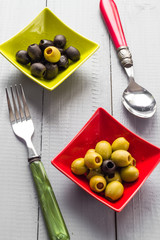 Colorful fruits olives bowls wooden table cutlery
