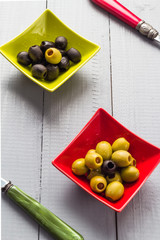 Colorful fruits olives bowls wooden table cutlery