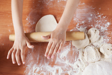 Child holding kneading dough