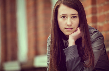Wistful sad attractive young woman