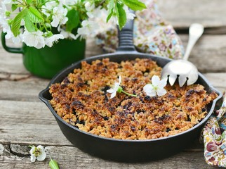 homemade blueberry crumble on  wooden table