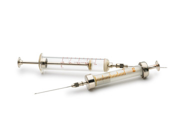 Two glass syringes isolated on white background