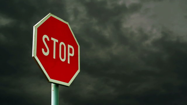 Red stop sign on the street. Roadside traffic sign for stopping