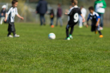 Obraz na płótnie Canvas Kids playing soccer