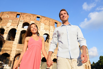 Couple in Rome by Colosseum walking holding hands