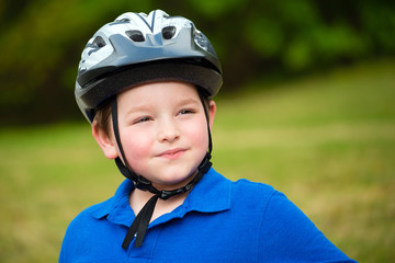 Happy child wearing a bike helmet outdoors