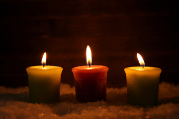Fototapeta na wymiar Burning candles on wooden background