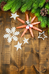 Beautiful snowflakes with fir branch on wooden background