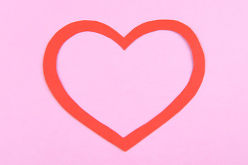 Paper heart on pink background