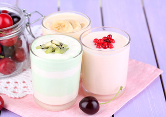 Delicious yogurt with fruits tastes in glasses and fresh fruits