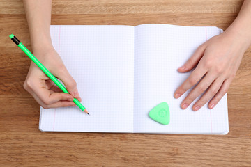 Human hands with pencil writing