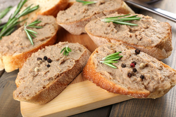Fresh pate with bread on wooden table