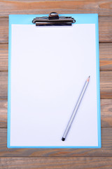 Clipboard on wooden background