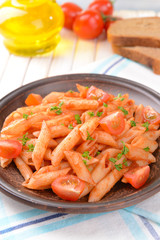 Pasta with tomato sauce on plate on table close-up