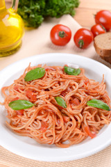 Pasta with tomato sauce on plate on table close-up