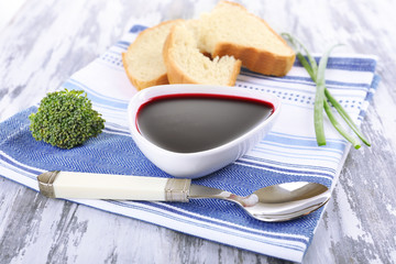 Bowl of beet soup on wooden table