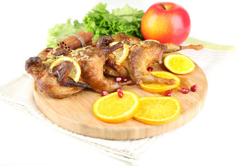 Roasted quails  on cutting board, isolated on white