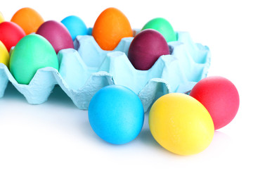 Colorful Easter eggs in tray isolated on white