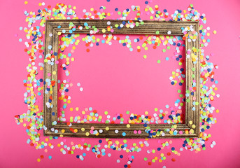 Photoframe with confetti on pink background
