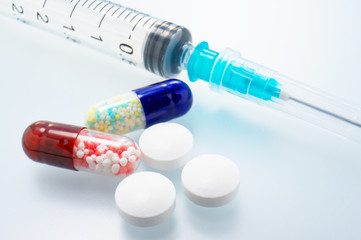 Closeup of medicines and syringes.